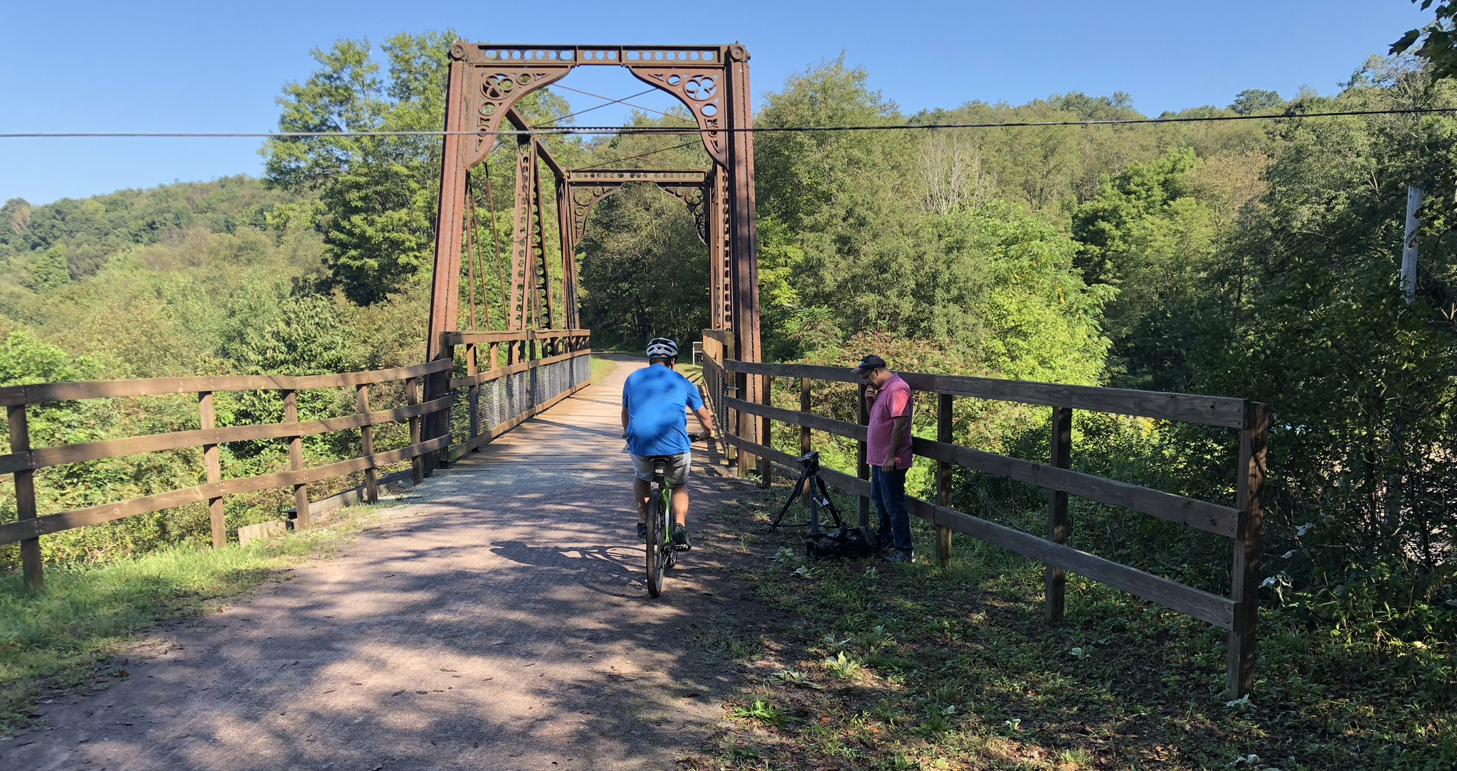 A biker crosses the historic Bollman Bridge on the Great Allegheny Passage near Meyersdale, PA. Photo Credit: David Solomon.